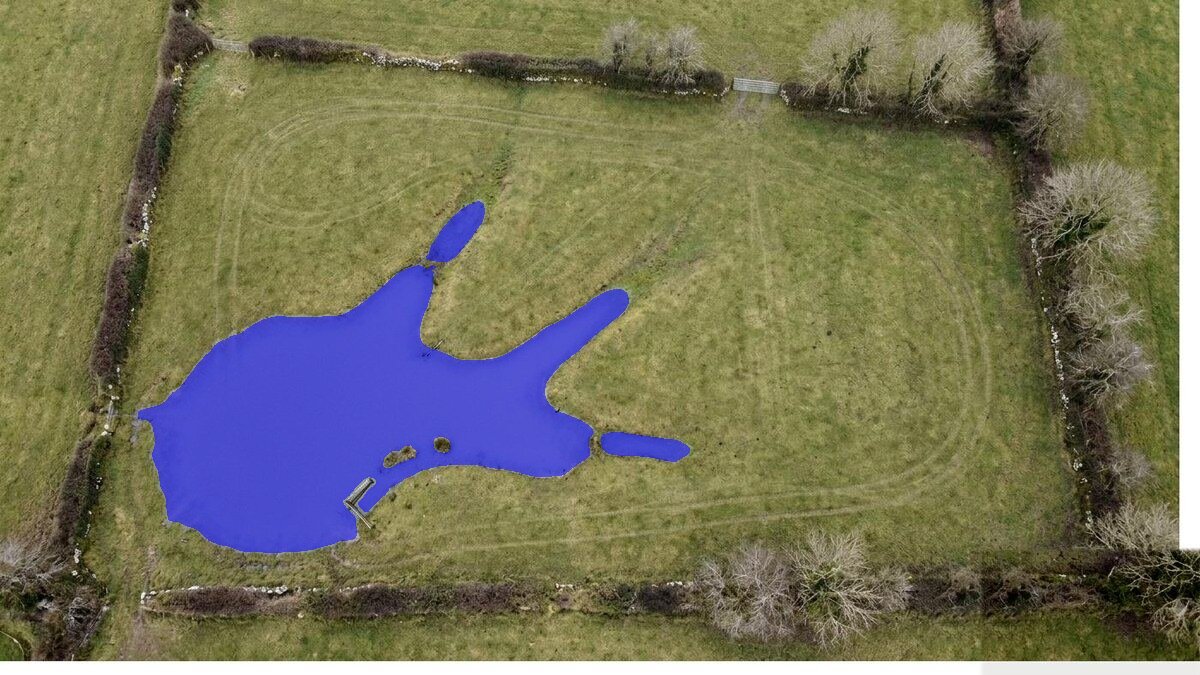The same aerial photograph with the flooded area highlighted in blue.